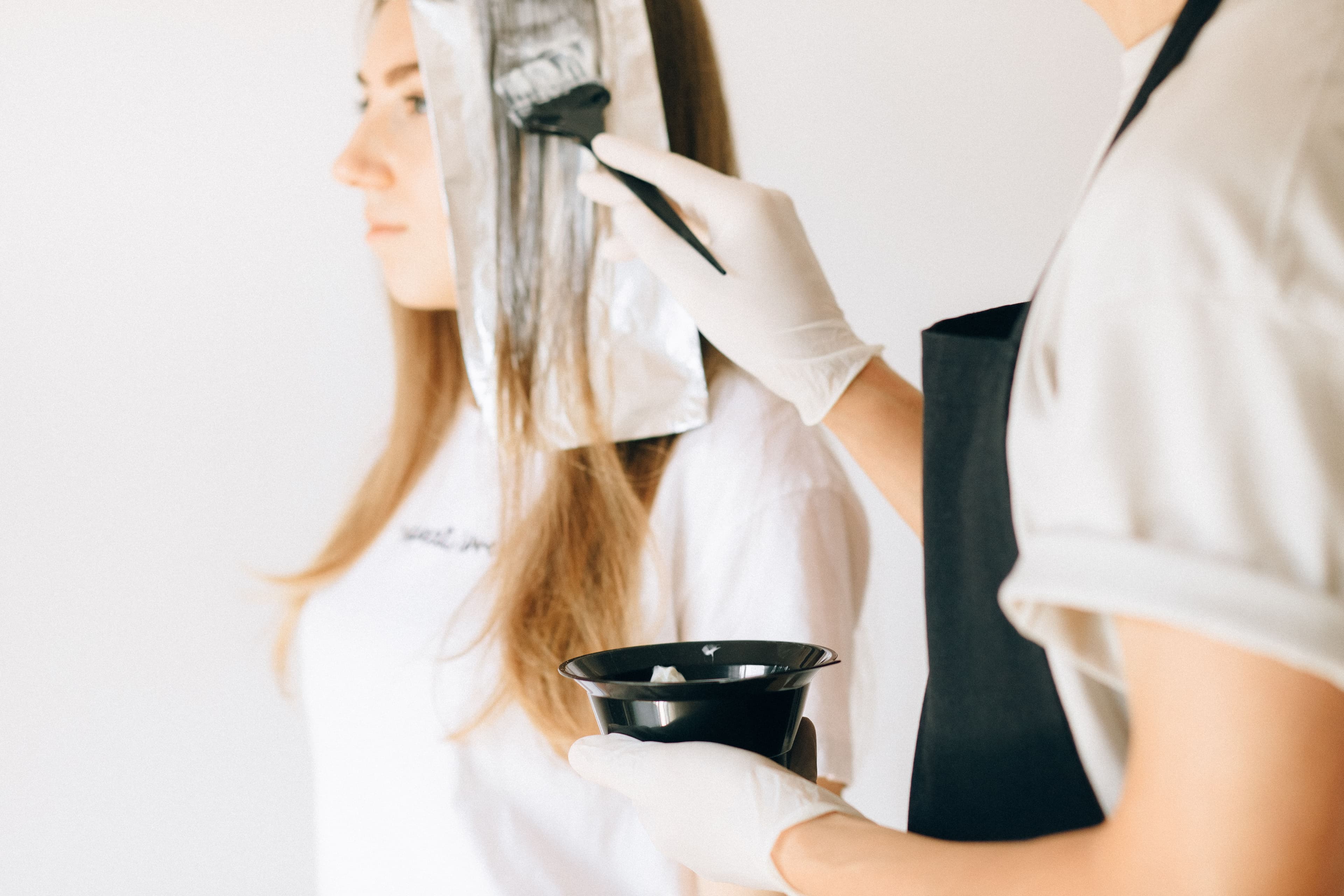 woman getting hair color applied.