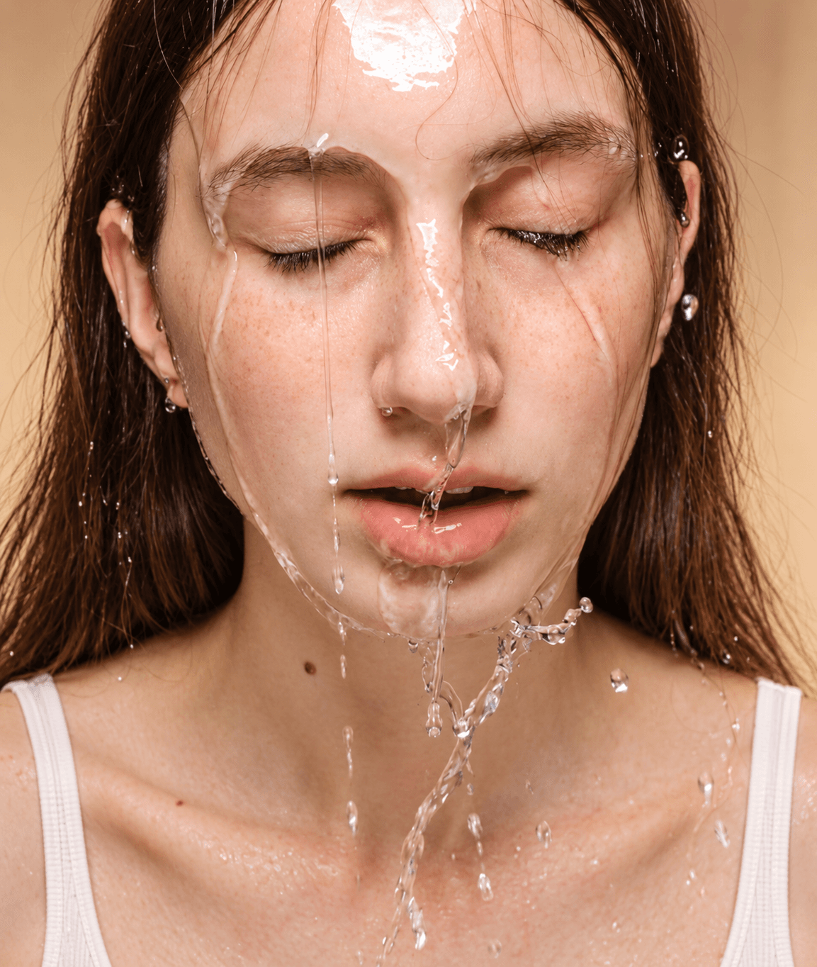 Woman with water being poured on her face.
